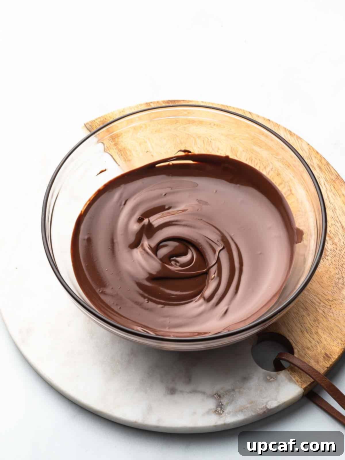 Microwave-melted chocolate, smooth and glossy in a bowl.