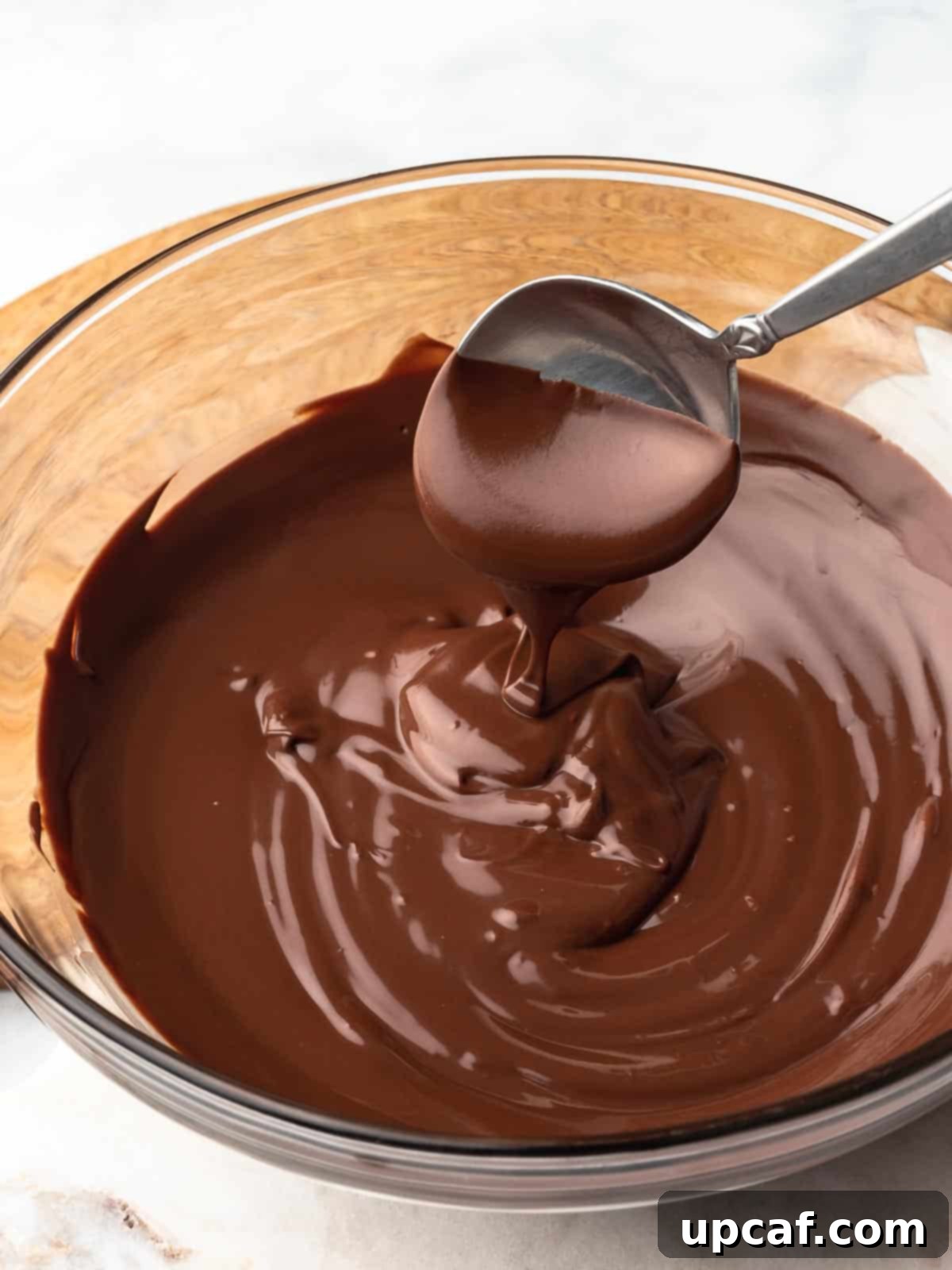 A large serving bowl filled with various chocolate-dipped fruits and treats, showcasing the versatility of melted chocolate.