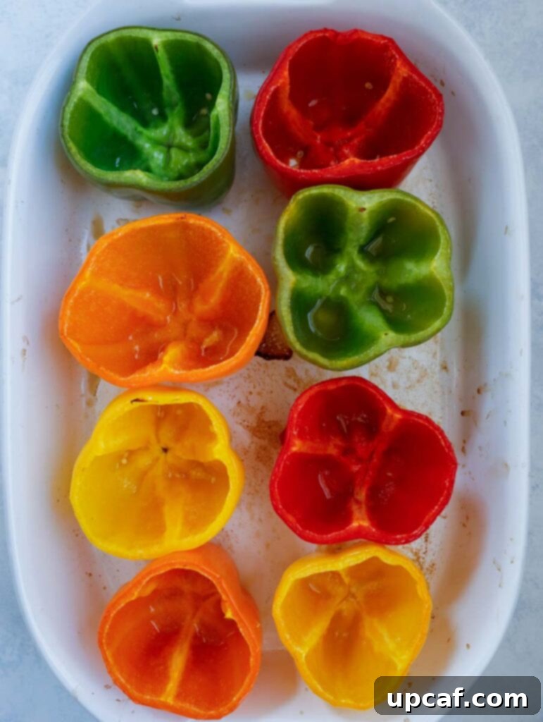 Nutrient-Packed Bell Pepper Boats 3 hollowed peppers in a baking dish.