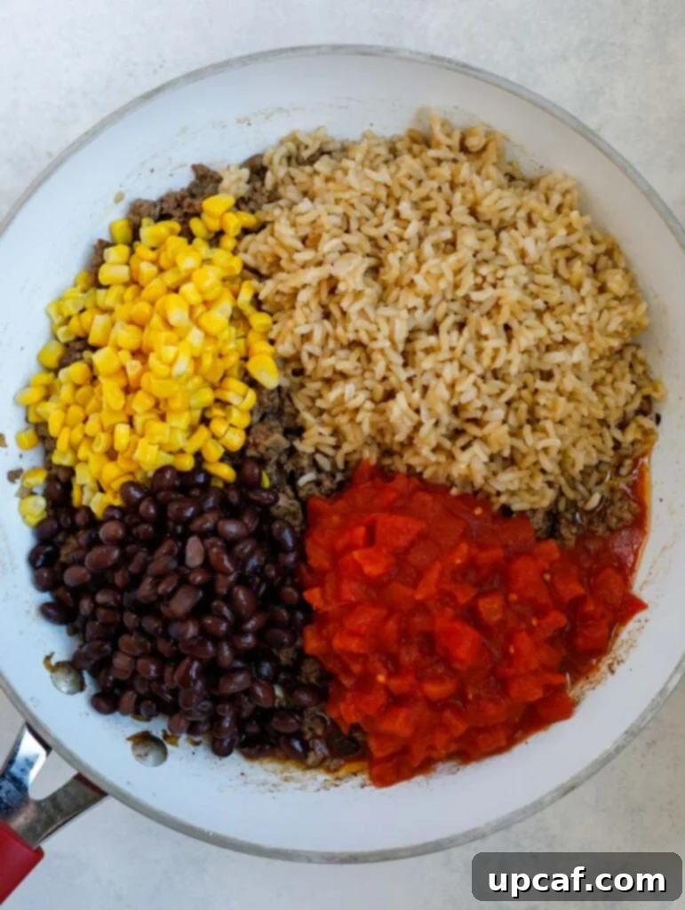 Nutrient-Packed Bell Pepper Boats 5 beans, tomatoes, rice and corn in a skillet.