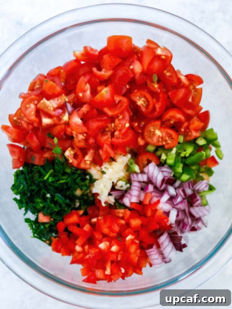 Zesty Shrimp Avocado Boats 3 A collection of fresh ingredients for shrimp stuffed avocados, neatly arranged in a glass bowl, showcasing their vibrant colors and readiness for preparation.