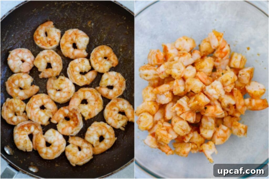 Zesty Shrimp Avocado Boats 4 Close-up shot of seasoned shrimp cooking in a hot skillet with olive oil, ready to be prepared for the avocado filling.