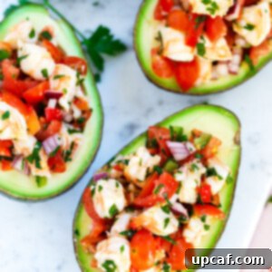 Zesty Shrimp Avocado Boats 7 A close-up, top-down view of a Healthy Shrimp Stuffed Avocado in a serving dish, highlighting the colorful filling and creamy texture.