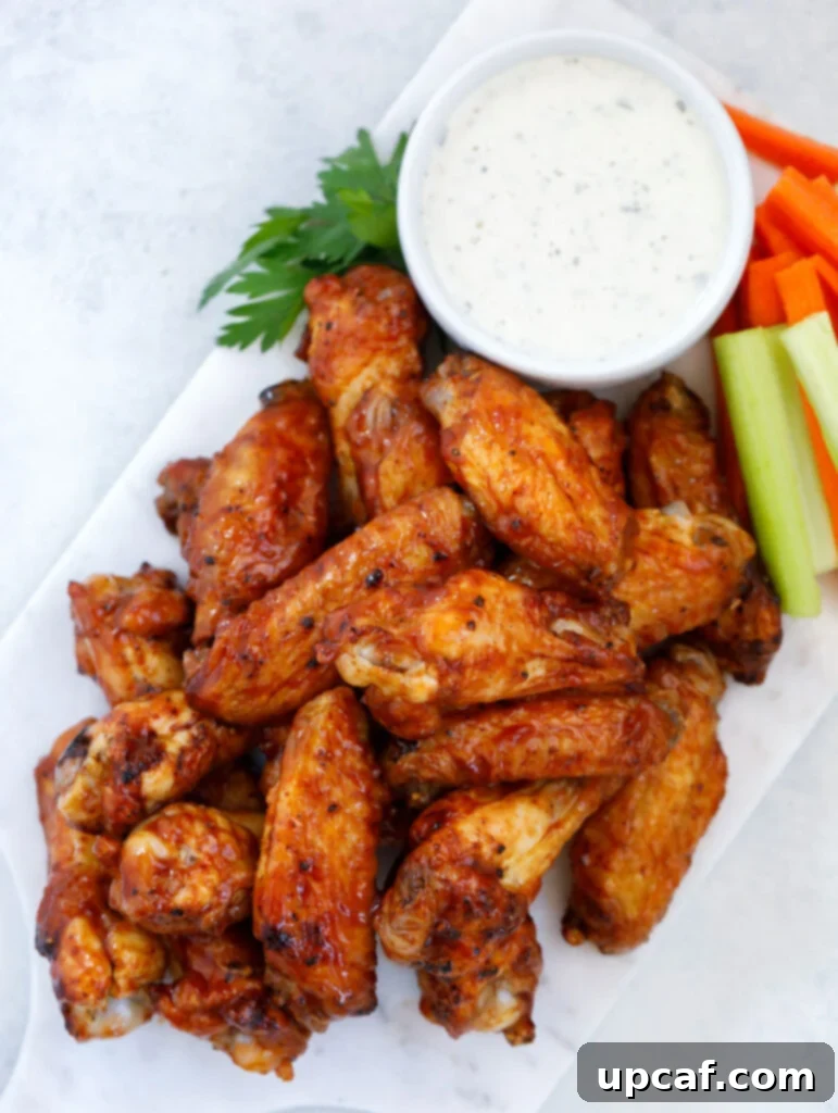 A close-up of a plate filled with crispy Air Fryer Chicken Wings, perfectly golden brown and ready to be enjoyed.