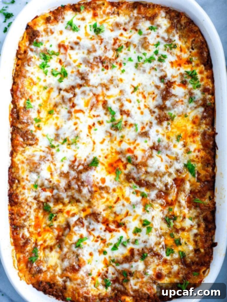 A whole Meat Lasagna beautifully presented in a white baking dish, ready to be served.