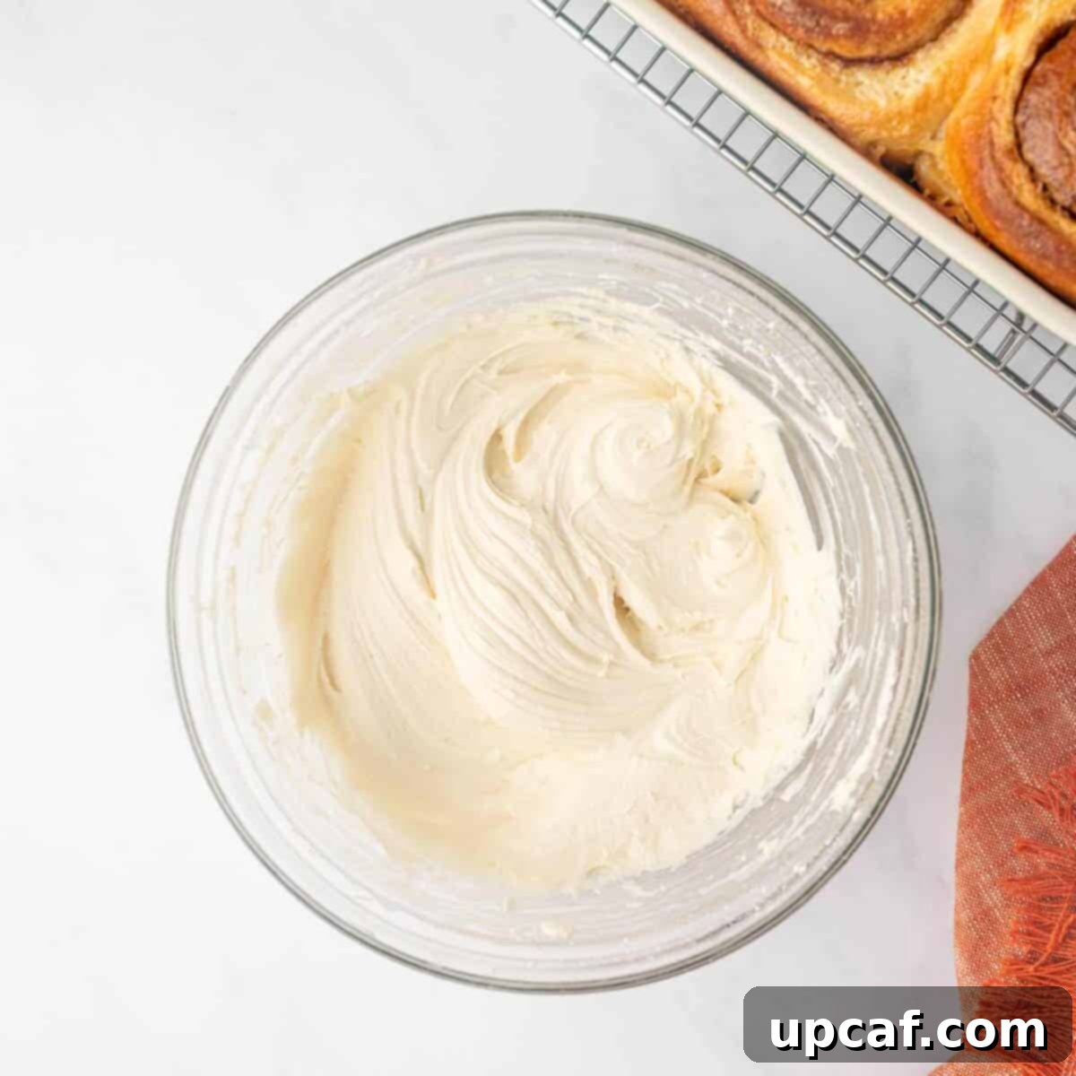 Bakery-Style Cinnamon Rolls: Extra Soft, Gooey, and Irresistibly Creamy 15 Cream Cheese Frosting in a Clear Bowl