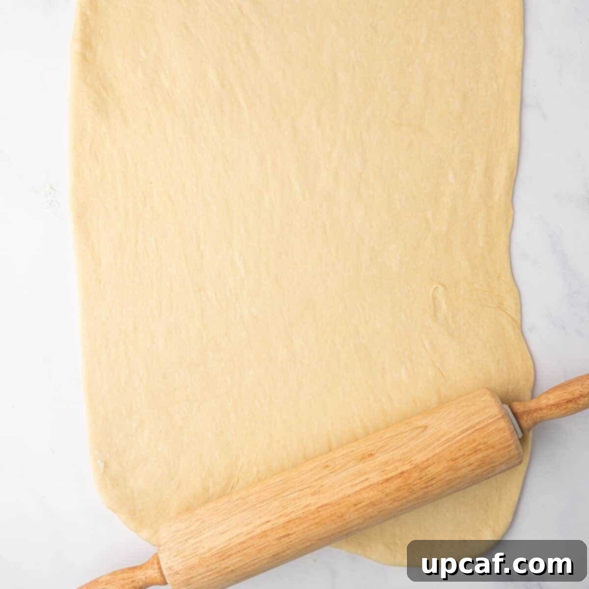 Bakery-Style Cinnamon Rolls: Extra Soft, Gooey, and Irresistibly Creamy 9 Rolling Out Cinnamon Roll Dough into a Rectangle